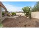 Desert landscaped backyard with gravel and cacti, along with a covered patio at 6353 S Eagle Ct, Gold Canyon, AZ 85118