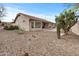 Desert landscaped backyard with a covered patio, mature cacti, and gravel ground cover at 6353 S Eagle Ct, Gold Canyon, AZ 85118