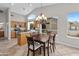 Open dining area with a chandelier and views, adjacent to kitchen with light wood cabinetry at 6353 S Eagle Ct, Gold Canyon, AZ 85118