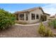 Back exterior showing covered patio, desert landscaping, and gravel ground cover at 6353 S Eagle Ct, Gold Canyon, AZ 85118