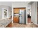Modern kitchen with stainless steel refrigerator and light-colored cabinets and granite countertops at 6353 S Eagle Ct, Gold Canyon, AZ 85118