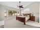 Cozy bedroom featuring a large window, ceiling fan, and comfortable wooden bed frame at 6353 S Eagle Ct, Gold Canyon, AZ 85118
