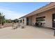 Covered patio area featuring lounge chairs, dining table, and view of landscaped backyard at 6353 S Eagle Ct, Gold Canyon, AZ 85118