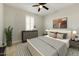 Bedroom featuring a Queen bed, an abstract artwork, neutral decor, and a ceiling fan at 6625 E Villa Rita Dr, Phoenix, AZ 85054