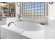 Bright bathroom with white oval tub and glass block window, allowing for natural light at 7144 W Villa Chula --, Glendale, AZ 85310