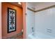 Bright bathroom with a tub and shower combination and unique tile accents at 7545 W Villa Rita Dr, Glendale, AZ 85308