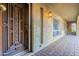 Intricate wood front door and stucco exterior with paver flooring at 7545 W Villa Rita Dr, Glendale, AZ 85308