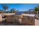 Outdoor kitchen featuring stone countertops, stainless steel grill, and bar seating at 7545 W Villa Rita Dr, Glendale, AZ 85308