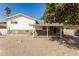 A house with a charming covered patio, a two-story design, and desert landscaping out back at 8407 E San Miguel Ave, Scottsdale, AZ 85250