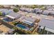 This aerial shot showcases the home's backyard oasis, complete with a pool, patio area, and lush landscaping at 8736 W Kathleen Rd, Peoria, AZ 85382