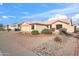 Single-story home with a desert landscape, complemented by a tan exterior and tile roof, perfect for low-maintenance living at 8736 W Kathleen Rd, Peoria, AZ 85382