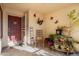 Cozy front porch with decorative butterflies, potted plants, and a rocking chair, creating a welcoming outdoor space at 8736 W Kathleen Rd, Peoria, AZ 85382