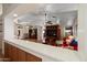 Spacious living room with hardwood floors, ceiling fans, and large media center at 8736 W Kathleen Rd, Peoria, AZ 85382