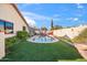 Sparkling backyard pool is surrounded by lush landscaping and artificial turf at 8736 W Kathleen Rd, Peoria, AZ 85382