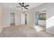 Spacious bedroom with ceiling fan, closet and bathroom access featuring carpeted floors at 8743 E Rose Ln, Scottsdale, AZ 85250