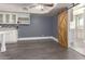 This kitchen area has white cabinets, a sliding barn door and wood-look floors at 901 E Scott Ave, Gilbert, AZ 85234