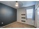 An empty bedroom featuring carpet, a black accent wall, a window, and a ceiling fan at 9383 E Silo Rd, Florence, AZ 85132