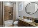 Traditional bathroom with a wood vanity, granite countertop, tiled shower, and classic fixtures at 9412 E Hidden Spur Trl, Scottsdale, AZ 85255