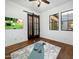 Versatile room with barn door, tv, and wood flooring, ideal for home gym at 9412 E Hidden Spur Trl, Scottsdale, AZ 85255