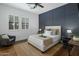 Stylish bedroom featuring a dark blue accent wall, neutral decor, and plenty of natural light at 9412 E Hidden Spur Trl, Scottsdale, AZ 85255