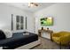 Bright bedroom with a cozy yellow chair, modern desk, and a wall-mounted TV for entertainment at 9412 E Hidden Spur Trl, Scottsdale, AZ 85255