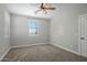Cozy bedroom featuring a ceiling fan, neutral carpet, and a window with plantation shutters at 9412 E Hidden Spur Trl, Scottsdale, AZ 85255
