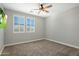 Inviting bedroom with plush carpeting, shuttered windows, and a modern ceiling fan at 9412 E Hidden Spur Trl, Scottsdale, AZ 85255