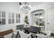 Dining room with a modern chandelier, an accent wall and direct access to outdoor seating at 9412 E Hidden Spur Trl, Scottsdale, AZ 85255