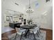 Open dining area with vaulted ceilings, chandelier, white chairs, and seamless flow to the kitchen at 9412 E Hidden Spur Trl, Scottsdale, AZ 85255