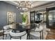 Stylish dining room featuring a round table, elegant chandelier, and sophisticated decor at 9412 E Hidden Spur Trl, Scottsdale, AZ 85255