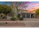 Charming two-story home featuring stucco exterior, tile roof, a three-car garage and desert landscaping at 9412 E Hidden Spur Trl, Scottsdale, AZ 85255