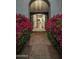 A welcoming front entrance with decorative iron doors that open to a lovely foyer at 9412 E Hidden Spur Trl, Scottsdale, AZ 85255