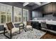 Bright home office featuring stylish seating, custom cabinets, and a view to the outdoors at 9412 E Hidden Spur Trl, Scottsdale, AZ 85255
