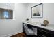 Bright office space featuring a built-in desk, custom cabinets, and a comfortable gray chair at 9412 E Hidden Spur Trl, Scottsdale, AZ 85255