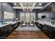 Well-lit home office with custom built-ins, modern lighting, and hardwood flooring at 9412 E Hidden Spur Trl, Scottsdale, AZ 85255