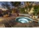 A relaxing hot tub area with a fire pit and outdoor seating, perfect for enjoying the evening at 9412 E Hidden Spur Trl, Scottsdale, AZ 85255