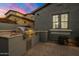 Outdoor kitchen with a built-in grill, stone counter, stainless steel doors, and charming accents at 9412 E Hidden Spur Trl, Scottsdale, AZ 85255