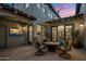 Outdoor patio features pavers, a fire pit, ambient lighting, and access to indoor dining at 9412 E Hidden Spur Trl, Scottsdale, AZ 85255