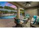 Relaxing outdoor patio with a view of the pool and a serene waterfall feature at 9412 E Hidden Spur Trl, Scottsdale, AZ 85255
