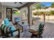 Outdoor patio area with ample seating, a ceiling fan, and views of a luxurious pool and water feature at 9412 E Hidden Spur Trl, Scottsdale, AZ 85255