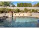 Inviting pool with a rock waterfall feature surrounded by lush landscaping at 9412 E Hidden Spur Trl, Scottsdale, AZ 85255