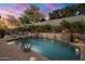 Scenic backyard showcasing a pool, spa, water feature, and a lounging space with towels and foliage at 9412 E Hidden Spur Trl, Scottsdale, AZ 85255