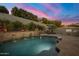 Backyard oasis featuring a sparkling pool with water features, and surrounding manicured landscape at 9412 E Hidden Spur Trl, Scottsdale, AZ 85255