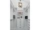 Custom walk-in closet with ample storage space, designer bags, and modern lighting at 9412 E Hidden Spur Trl, Scottsdale, AZ 85255