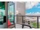 Balcony with a cozy seating area overlooking city views and clear railings at 1 E Lexington Ave # 1210, Phoenix, AZ 85012