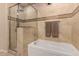 Luxurious bathroom showcases a soaking tub and glass-enclosed shower with neutral tile at 1 E Lexington Ave # 1210, Phoenix, AZ 85012