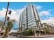 Modern high-rise building with a glass facade, palm trees and blue sky at 1 E Lexington Ave # 1210, Phoenix, AZ 85012