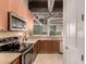 Modern kitchen features stainless steel appliances, light wood cabinets, and views of the city skyline at 1 E Lexington Ave # 1210, Phoenix, AZ 85012