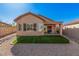 The backyard features artificial grass, desert landscaping, a covered patio, and views of neighboring houses at 10352 E Second Water Trl, Gold Canyon, AZ 85118