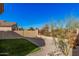 Landscaped backyard featuring artificial turf, gravel, decorative rocks, and a view of surrounding homes at 10352 E Second Water Trl, Gold Canyon, AZ 85118